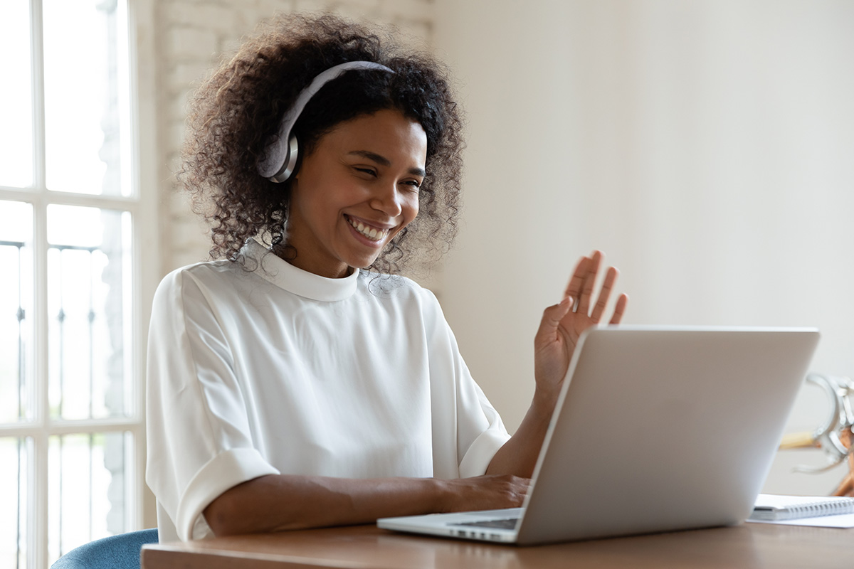 Woman wearing headphones communicating via video chat