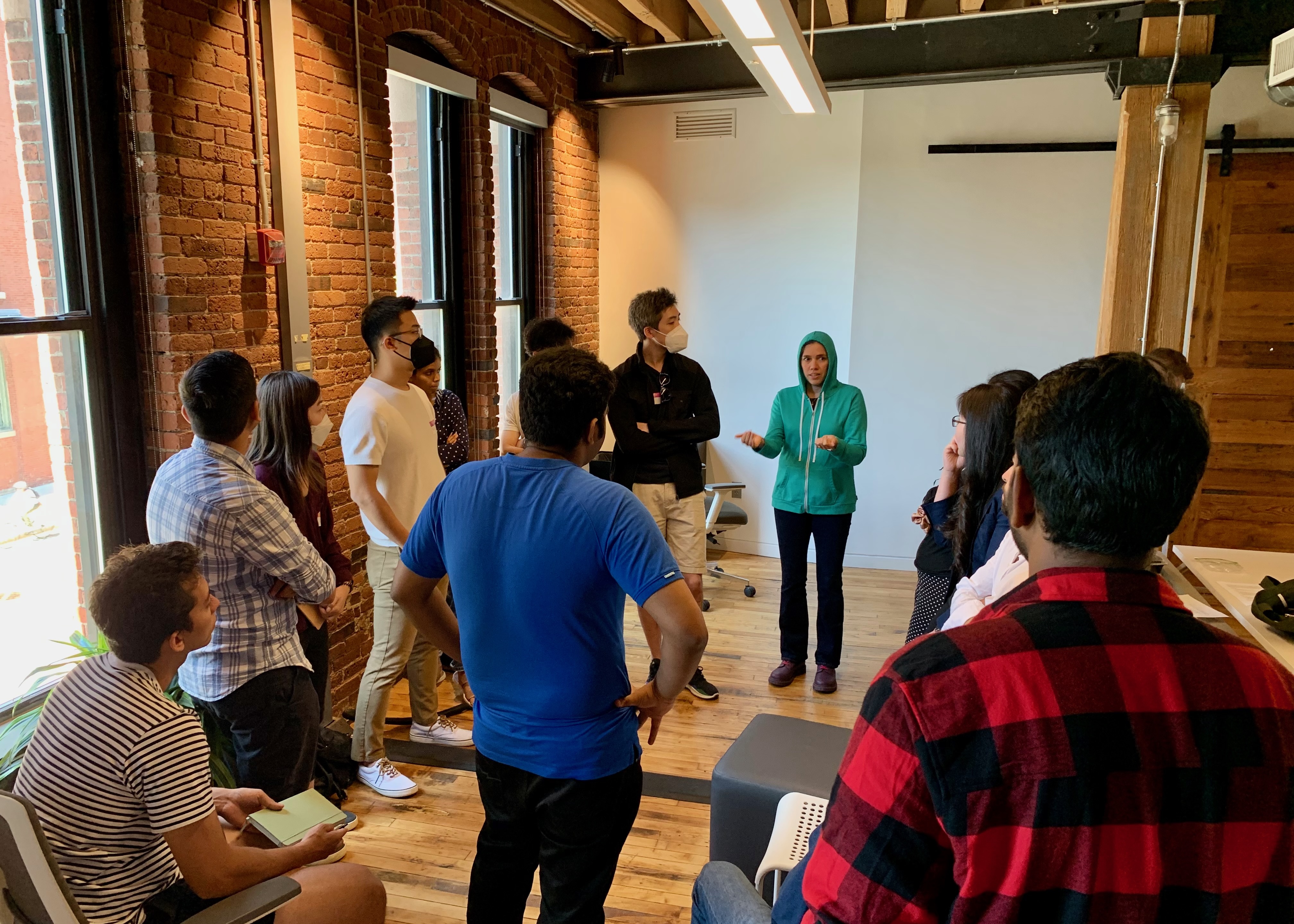 Cohere team members "holding court" with woman leading discussion