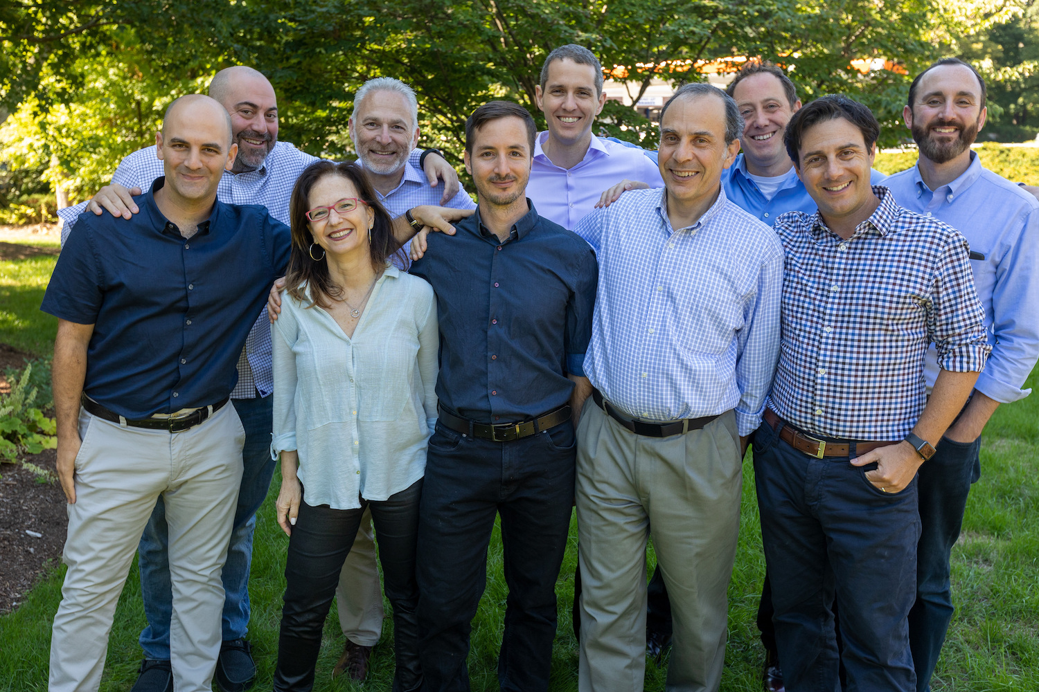 Ten people from Assured Allies’ management team pose for a group photo.