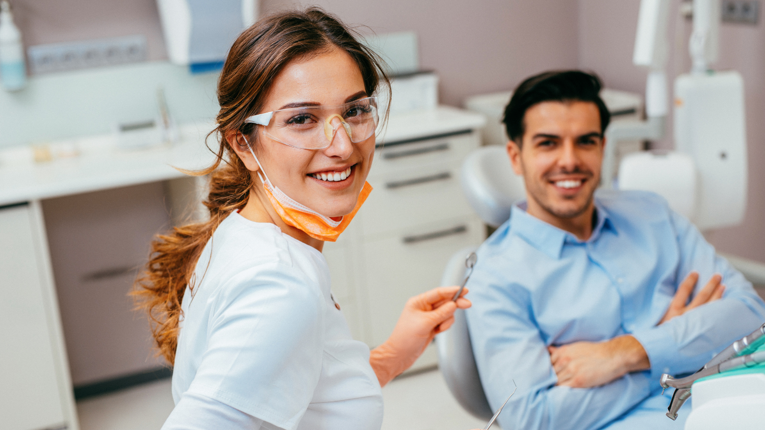 Dentist smiling in front of patient