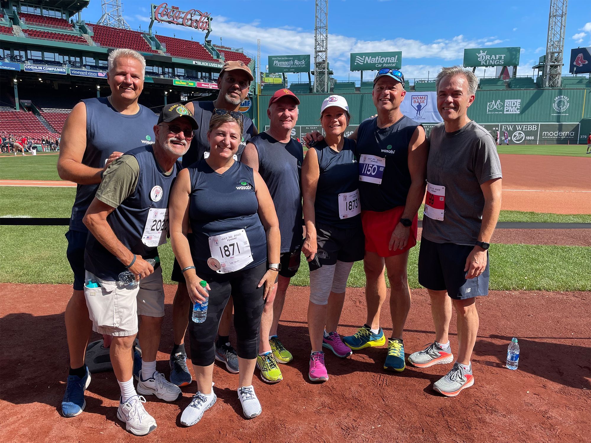  Group photo of Wasabi team members on the field at Fenway Park.