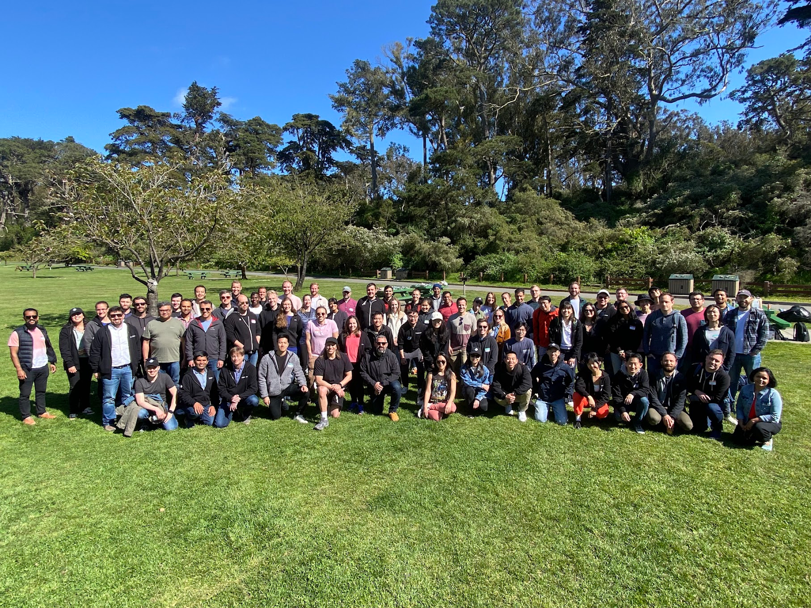 The team members who helped develop Dropbox Dash pose for a large group photo outside.