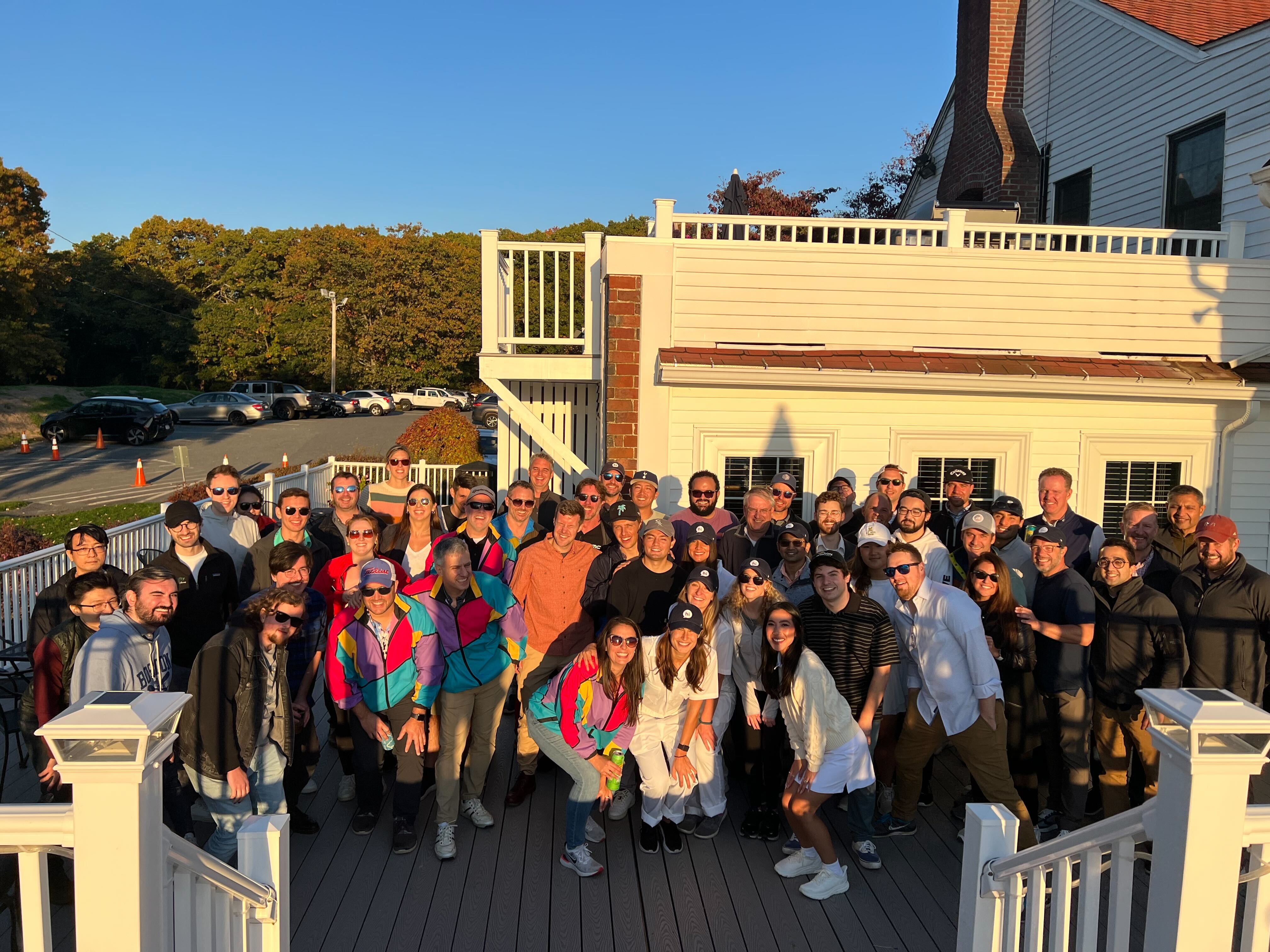 Hi Marley's employees posing cheerfully for a photo on a porch.