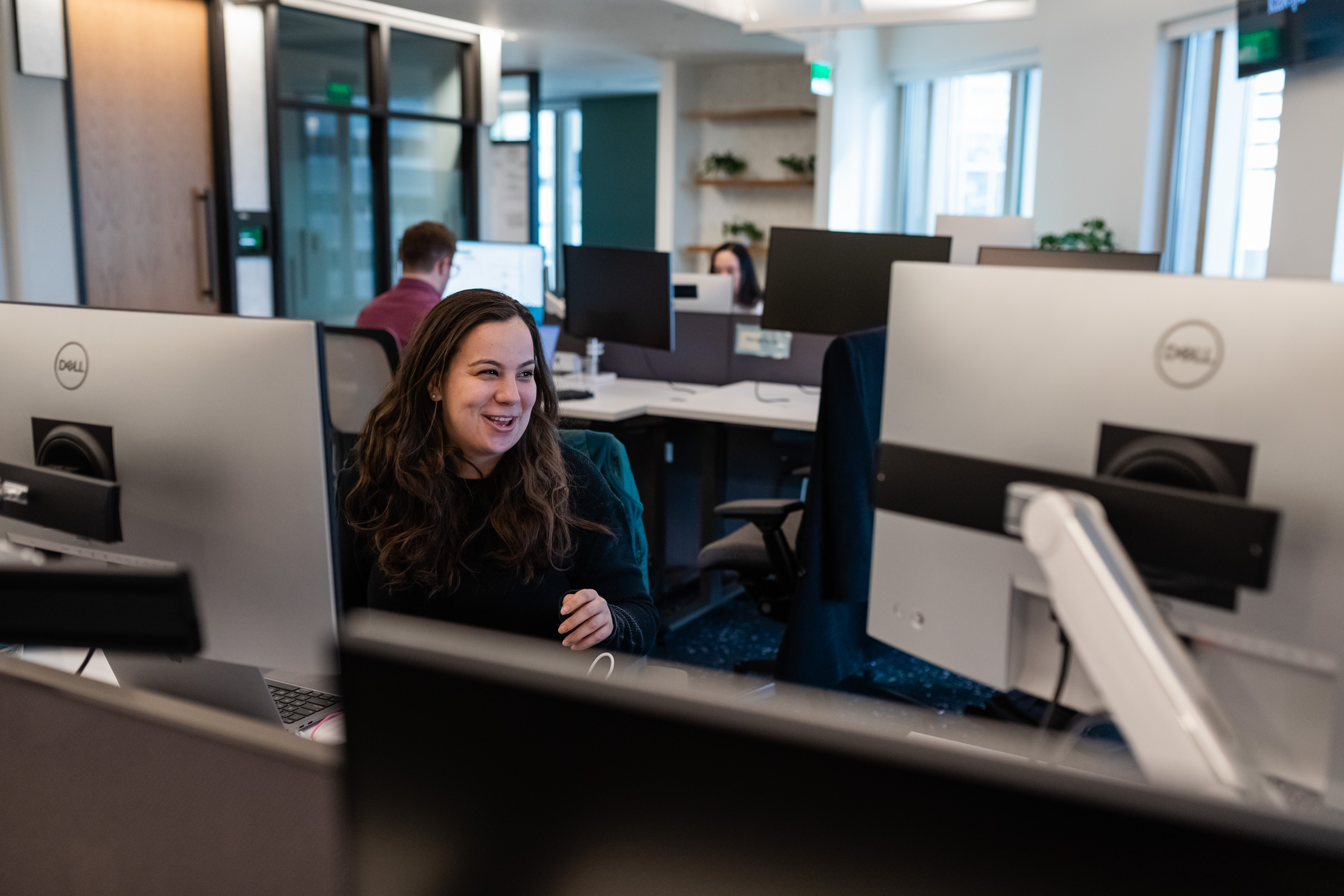 A team member works at their desk during a hackathon.