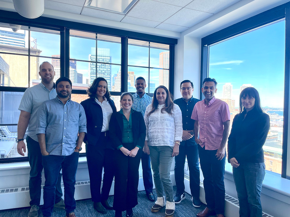 Linus Health team members standing by windows in the office