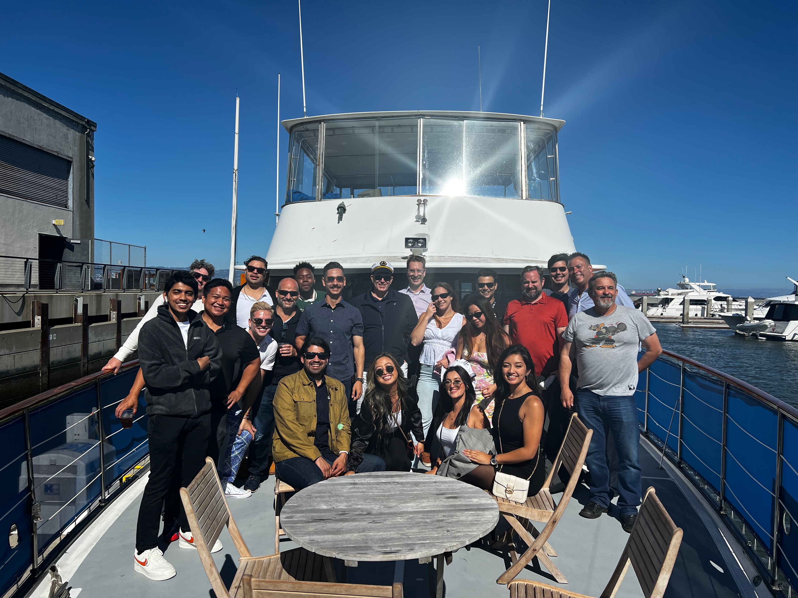 Members of Leyton's team posing for a group photo on a boat.