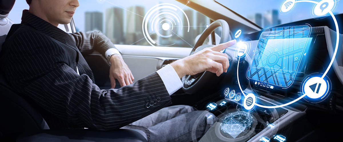 man using a digital screen inside of a car