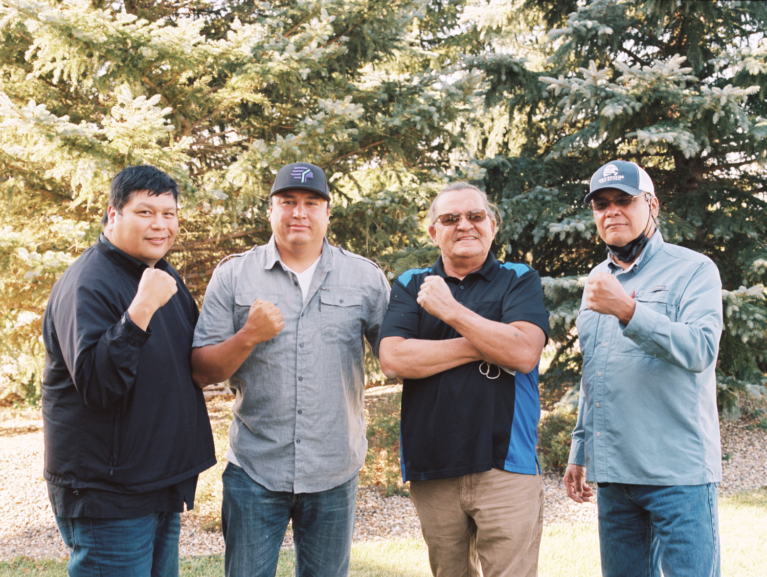 Indigenized Energy Initiative's team posing in front of evergreen trees.