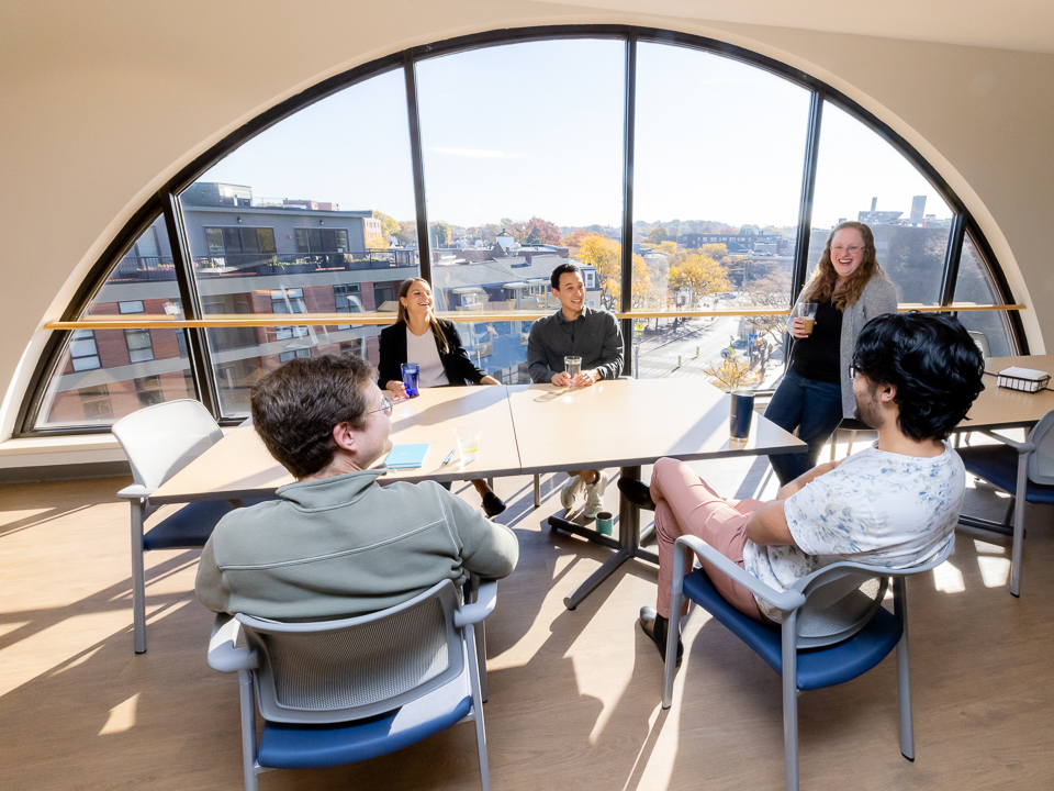 galatea associates team meeting in office with five employees