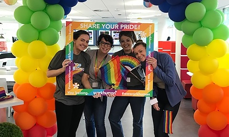 Workhuman team members with rainbow pride decorations