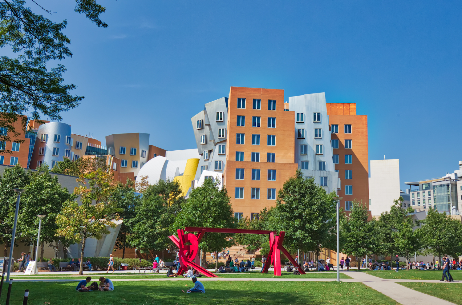 A red metal sculpture is pictured in front of the Stata Center on the MIT campus.