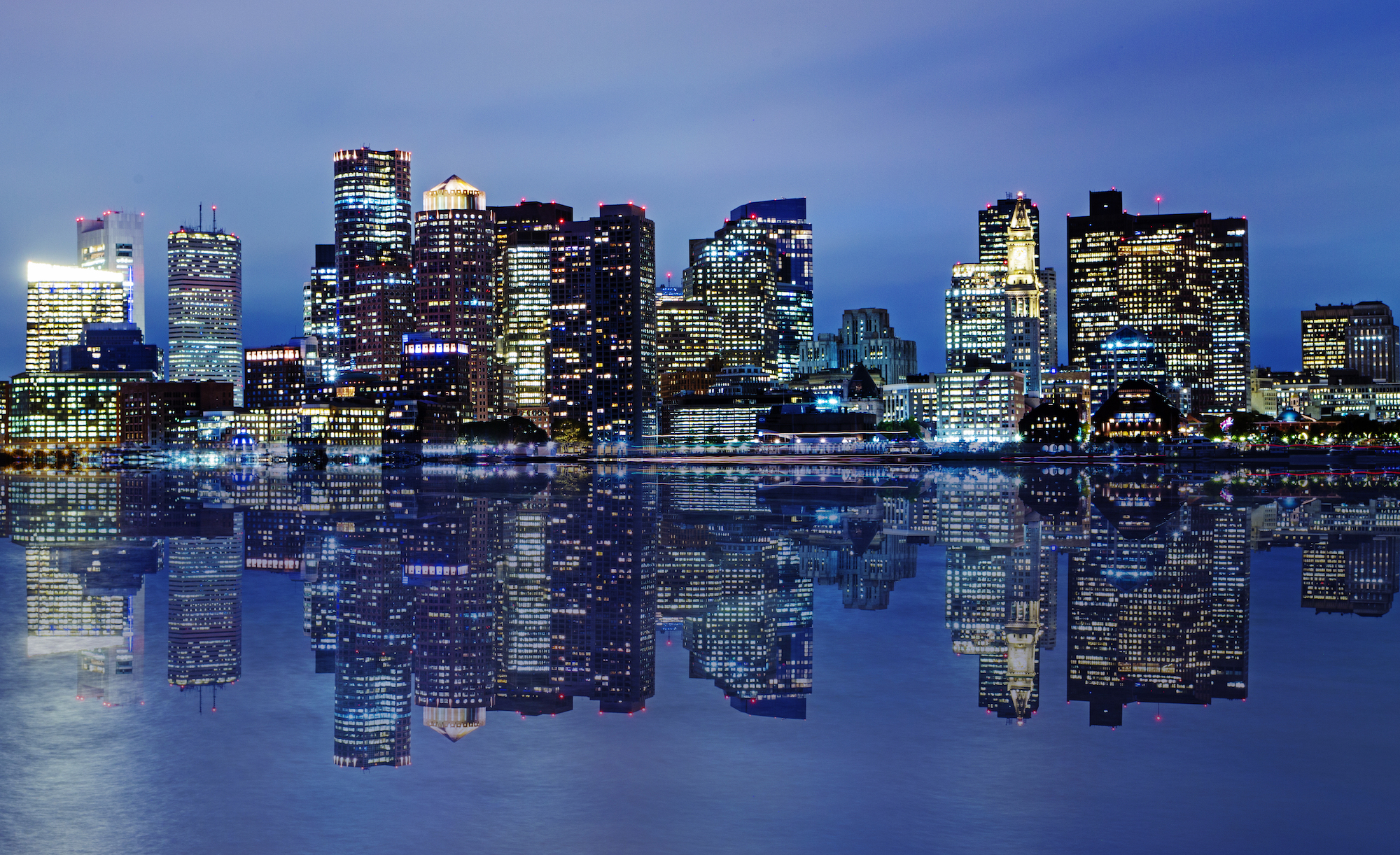 A nighttime photo of the Boston skyline.