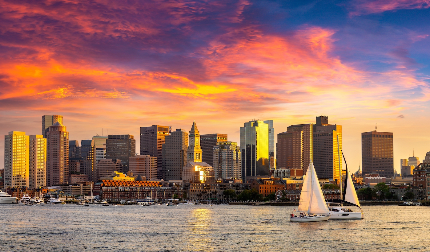 An evening photo of the Boston skyline.