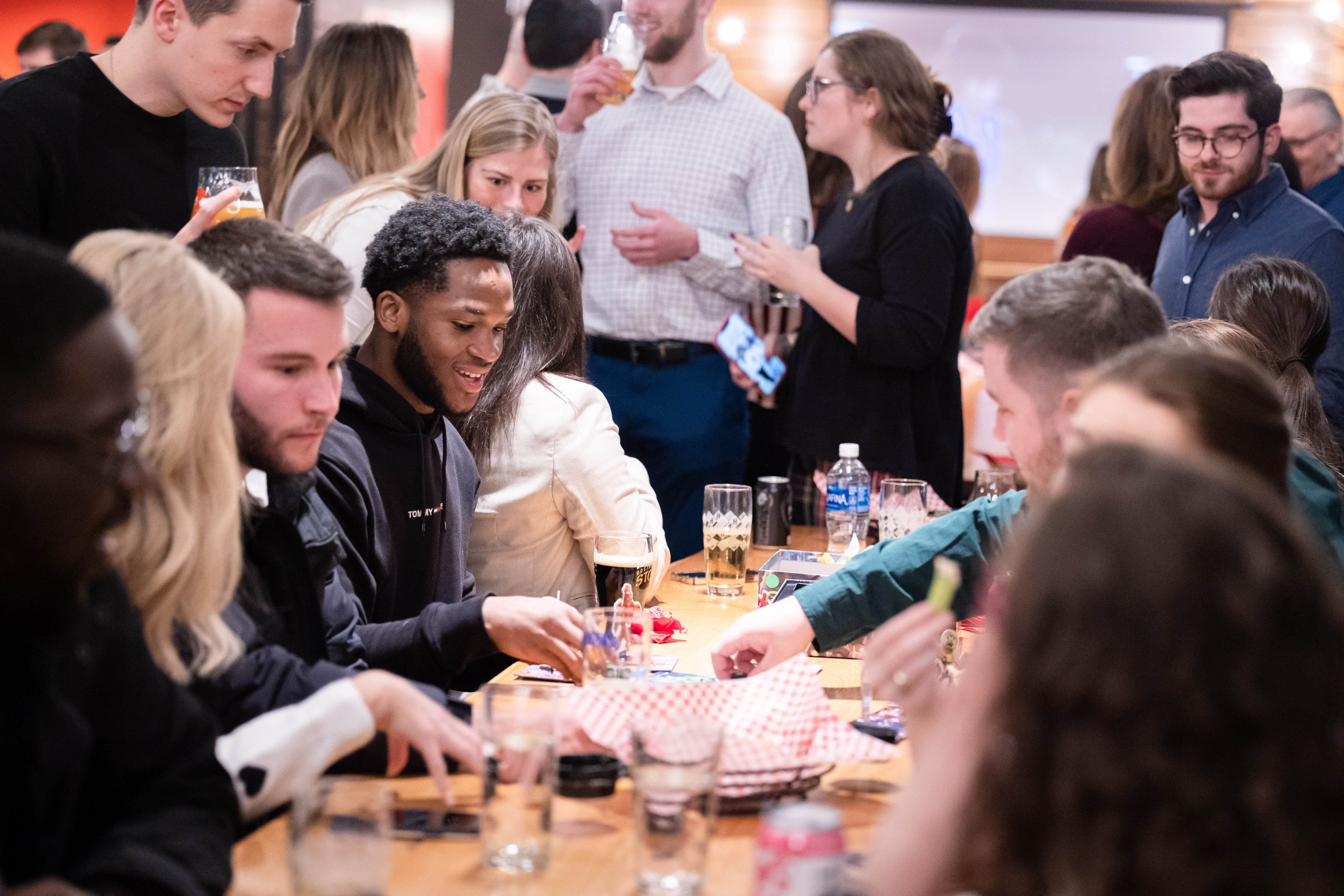 employees interacting at company social with food and drinks