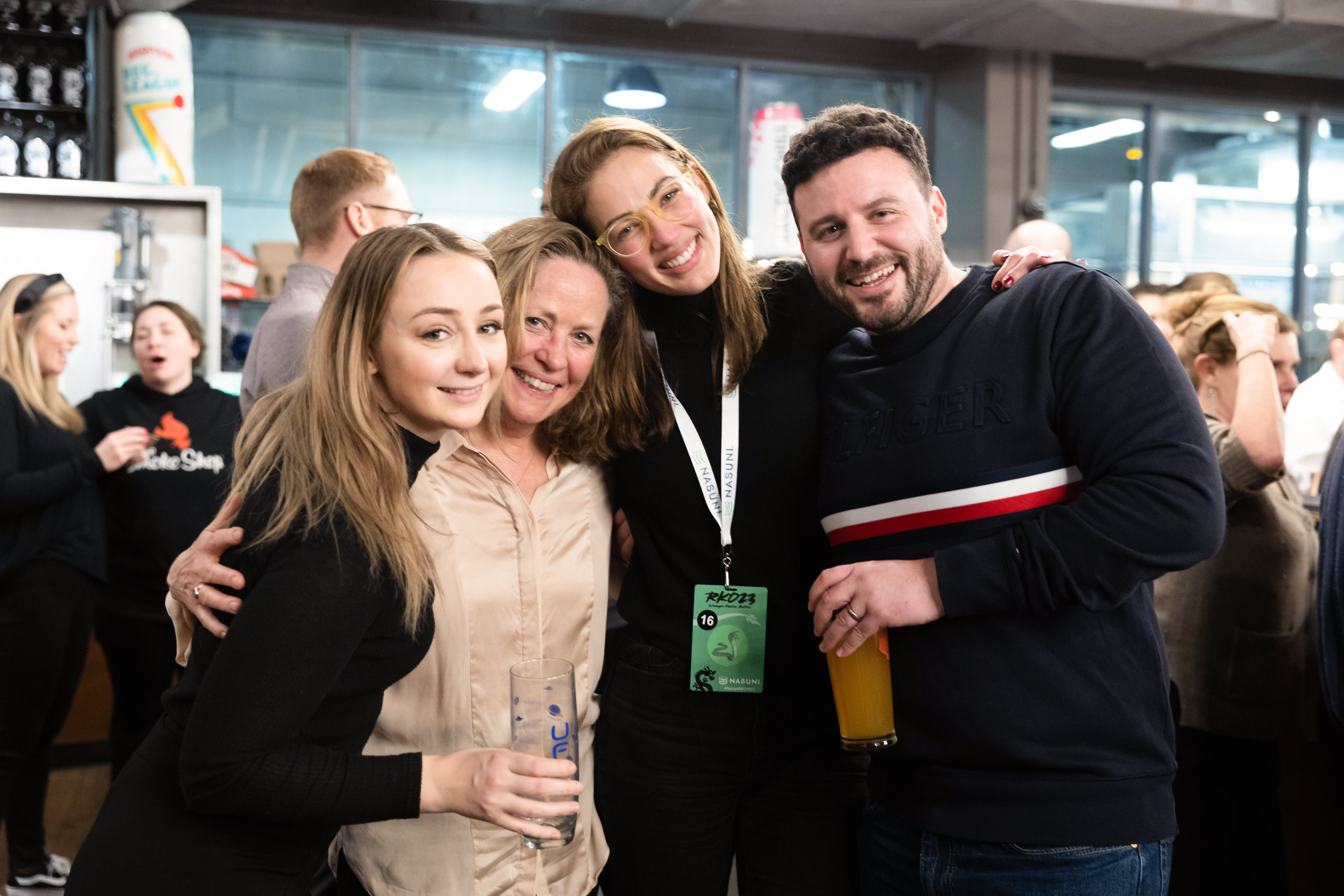 four employees take a team photo at an event