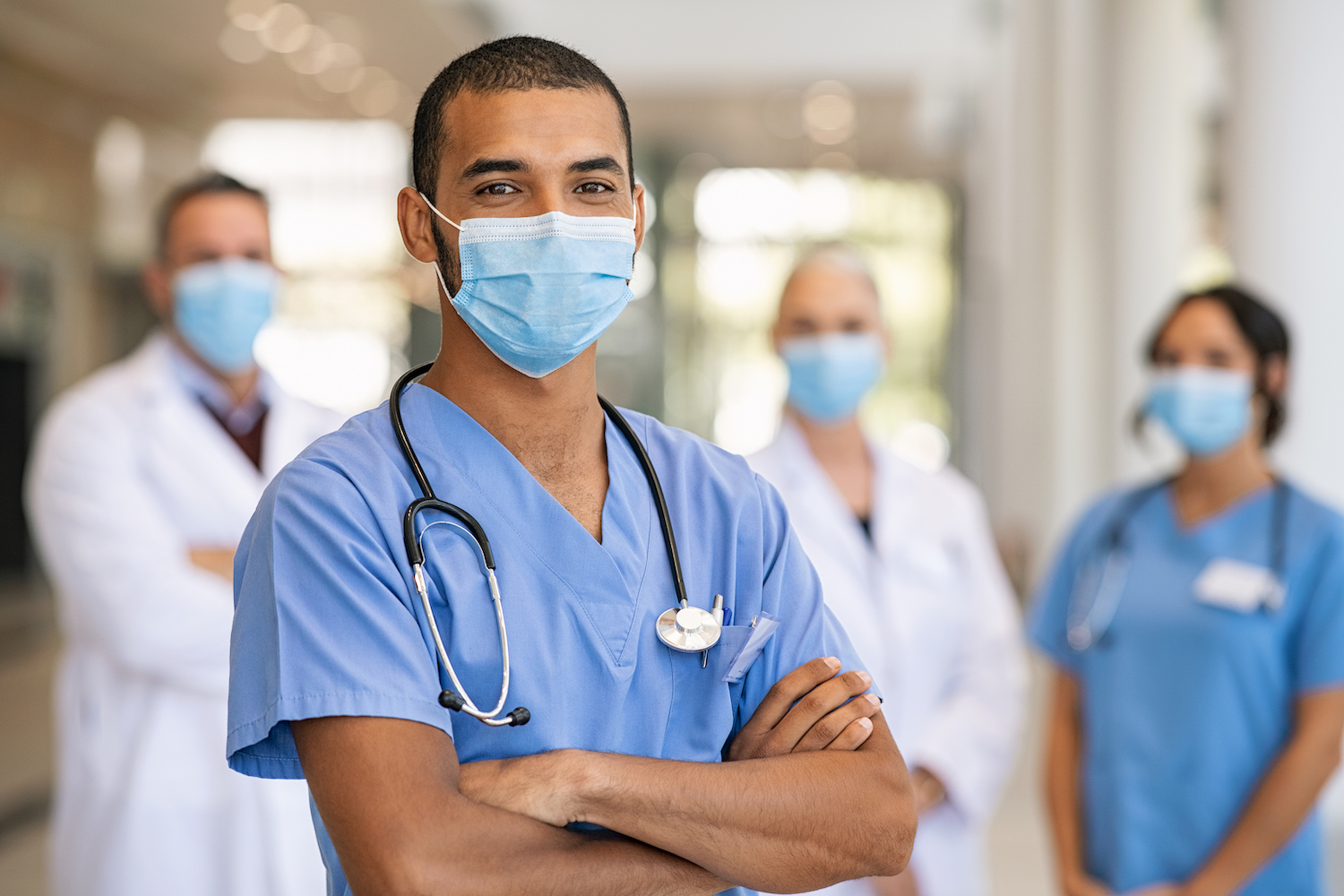 A group of nurses wearing face masks pose for a photo