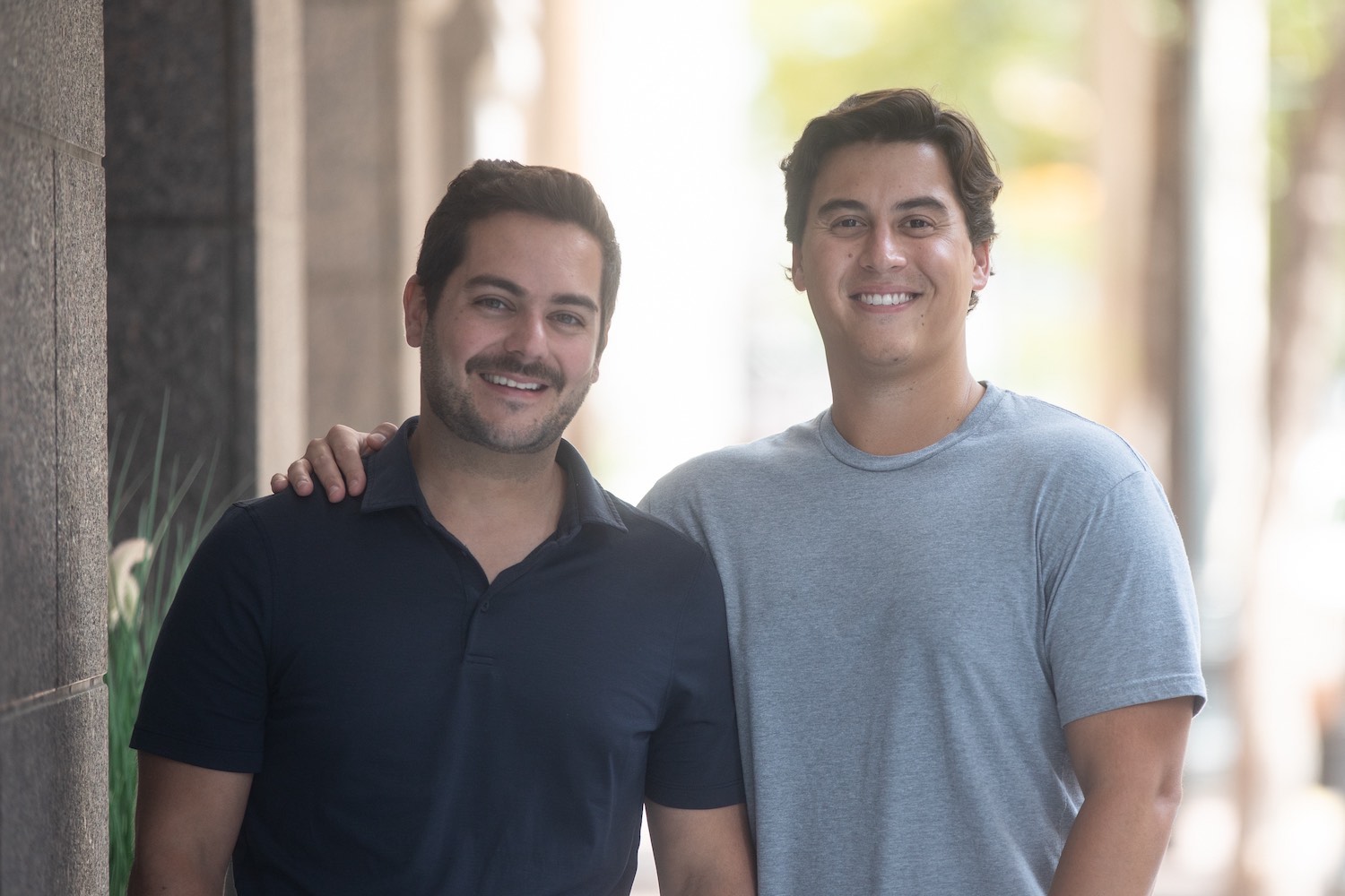 Relevize co-founders Michael Nardella and Peter Sidney smile outside a building