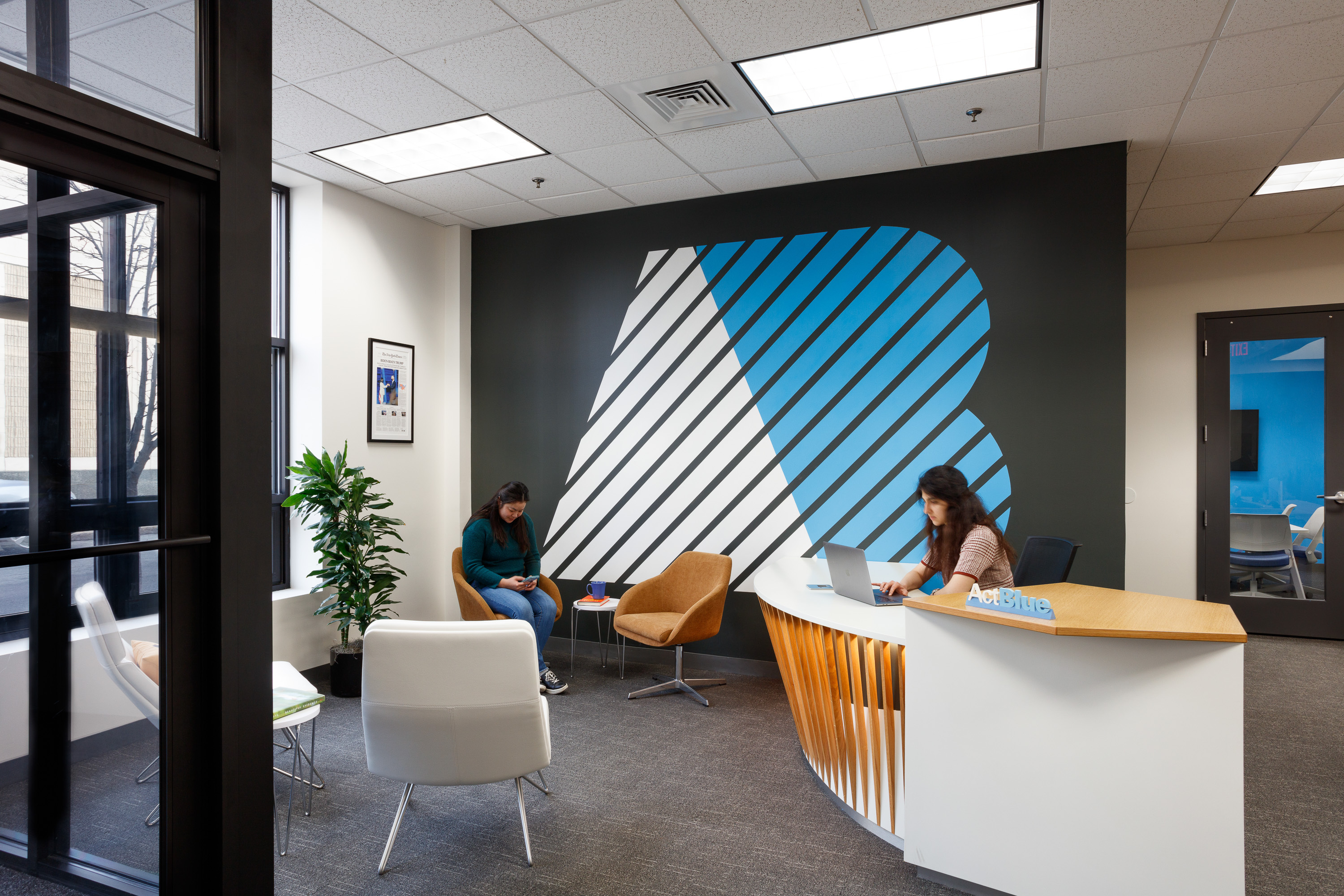 actblue office with two employees working on laptops