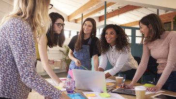 Image of five women coworkers collaborating