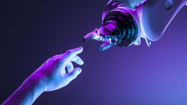 A human hand reaching out to connect with a robot hand. 