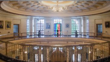 The rotunda at the office with a pride flag hanging in the window