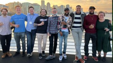 Reggora team photo outside with skyline in the background