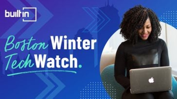 ​ custom builtin banner for built in boston's winter tech watch, with a blue background, city silhouette and a person working on a laptop ​