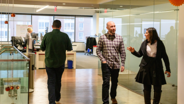 Lata Ahuja walking through the CarGurus Cambridge office with a coworker