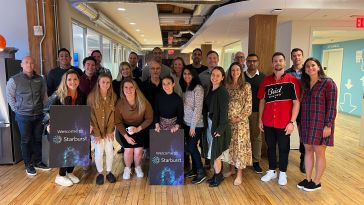 Starburst's team posing for a photo in their office.