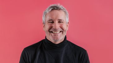 Zappi co-founder and CEO Steve Phillips is pictured against a pink background.