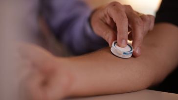 Vaxxas’ needle-free vaccine patch on someones arm.