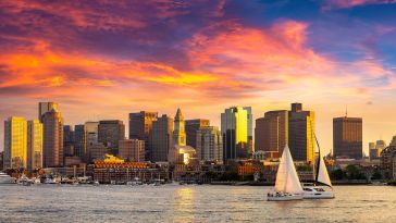 An evening photo of the Boston skyline.