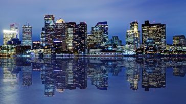 A nighttime photo of the Boston skyline.