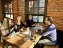 Photo of SmarterTravel coworkers eating a meal at the office.