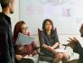 CarGurus team members in discussion during a meeting.