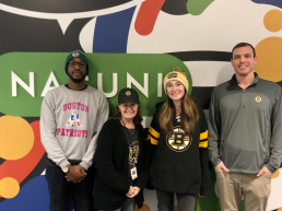 four employees standing in front of Nasuni mural 