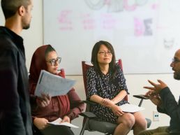 CarGurus team members in discussion during a meeting.